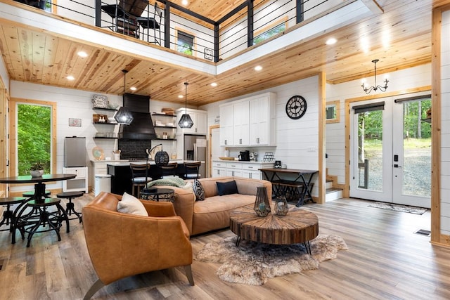 living area with wooden ceiling, light wood-style floors, and a wealth of natural light