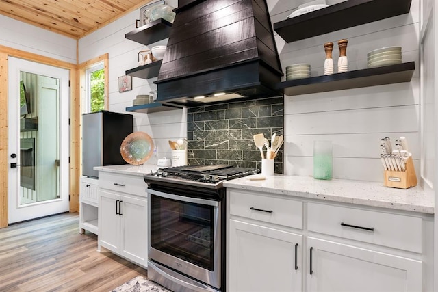 kitchen with open shelves, appliances with stainless steel finishes, custom exhaust hood, and white cabinetry