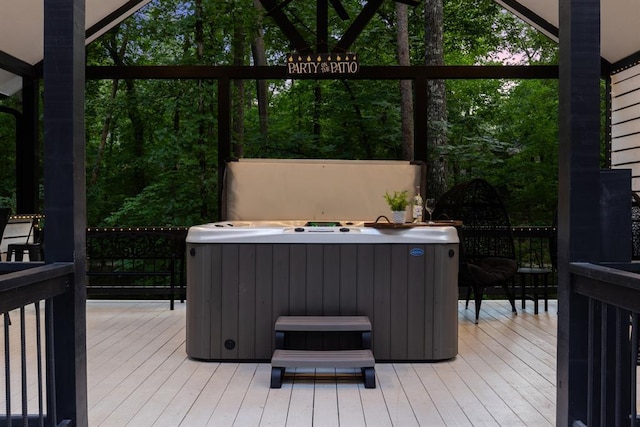 wooden deck with a hot tub