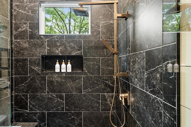 bathroom with a tile shower