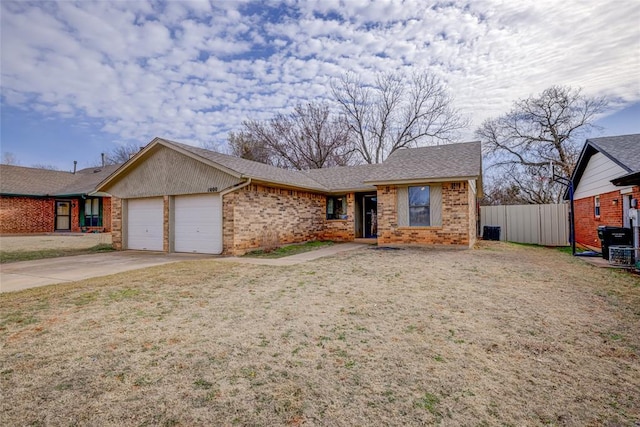 ranch-style home featuring fence, an attached garage, concrete driveway, a front lawn, and brick siding