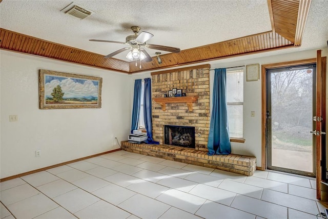 unfurnished living room featuring a tray ceiling, visible vents, and a textured ceiling