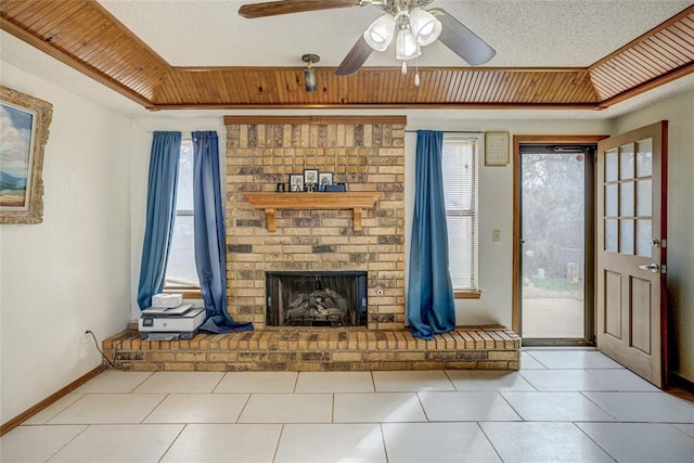 unfurnished living room with plenty of natural light, a fireplace, and a textured ceiling