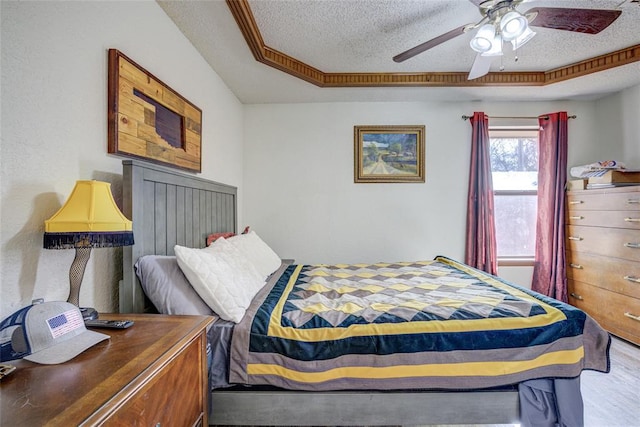 bedroom featuring a textured ceiling and a ceiling fan