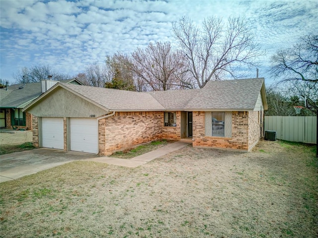 ranch-style house with an attached garage, fence, driveway, and roof with shingles