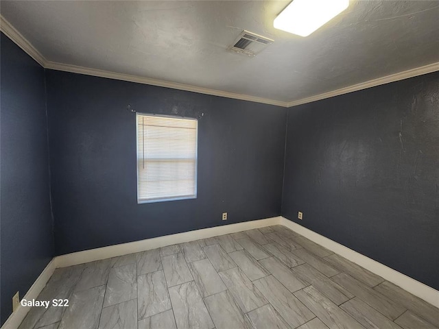 spare room with baseboards, visible vents, and ornamental molding