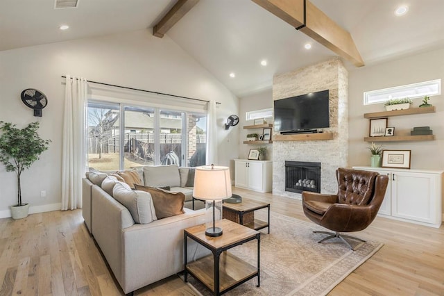 living room with baseboards, beam ceiling, a fireplace, light wood-style floors, and high vaulted ceiling