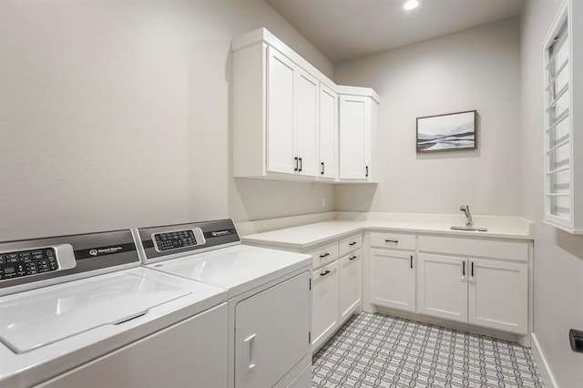 laundry room with a sink, recessed lighting, cabinet space, and washing machine and clothes dryer