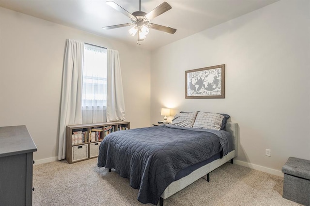 bedroom with baseboards, light carpet, and a ceiling fan