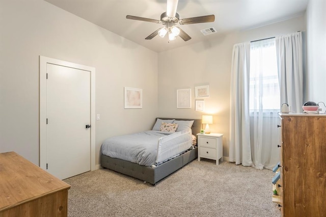 bedroom featuring visible vents, carpet floors, and a ceiling fan