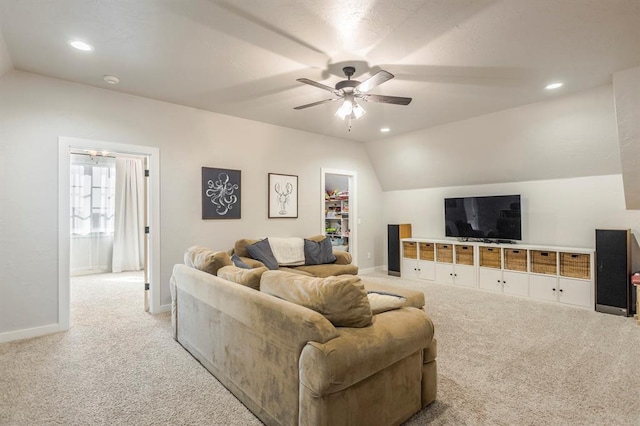 living room with baseboards, carpet, a ceiling fan, and vaulted ceiling