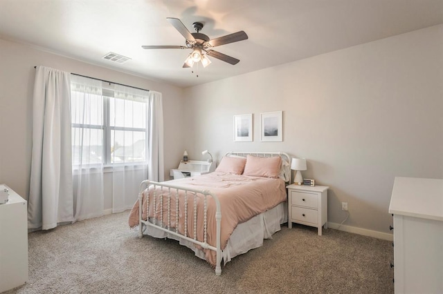 bedroom with visible vents, light colored carpet, a ceiling fan, and baseboards