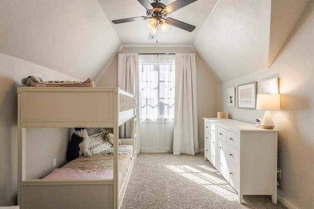 bedroom featuring vaulted ceiling, a ceiling fan, and light carpet