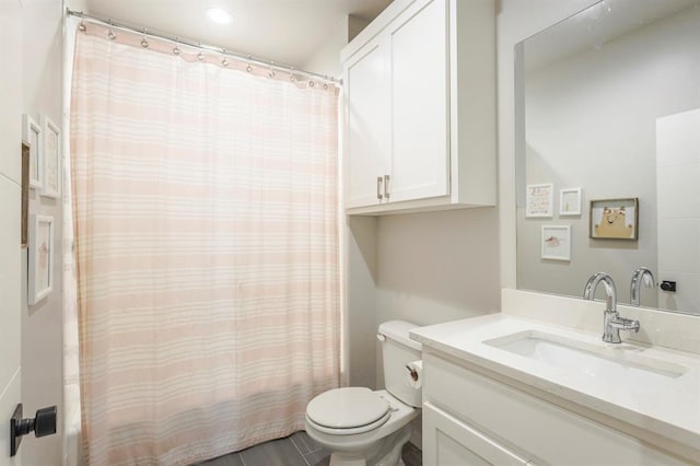 full bathroom featuring vanity, curtained shower, and toilet