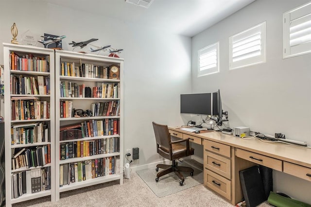 office area featuring baseboards and light colored carpet