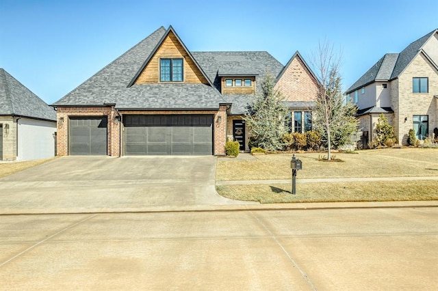 view of front of home featuring concrete driveway, brick siding, roof with shingles, a garage, and a front lawn