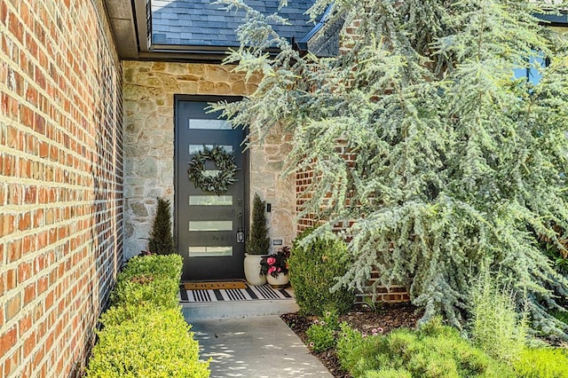 1401 Regency Bridge Cir, Edmond, OK 73034 - property entrance with stone siding and a shingled roof