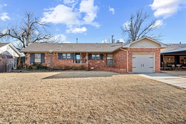 ranch-style home featuring driveway, roof with shingles, an attached garage, brick siding, and a chimney