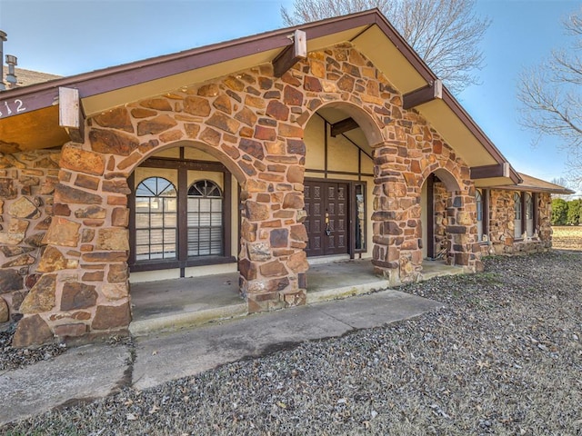 view of exterior entry with stone siding