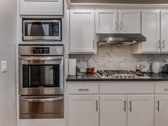 kitchen featuring under cabinet range hood, decorative backsplash, white cabinets, stainless steel appliances, and a warming drawer