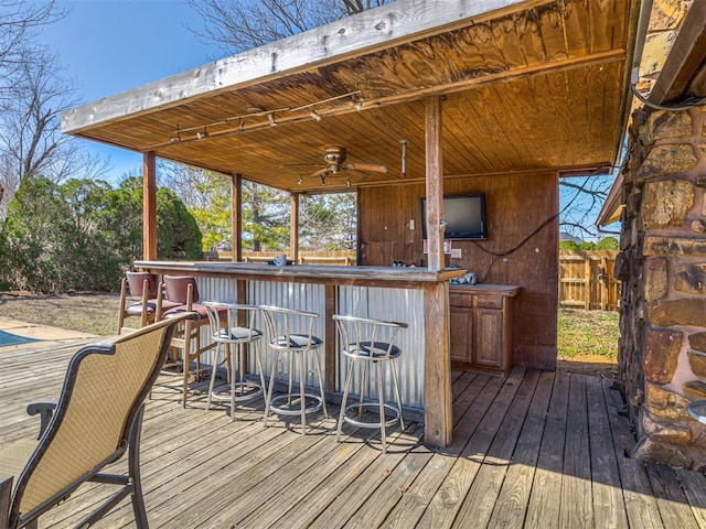 wooden terrace with fence and outdoor dry bar