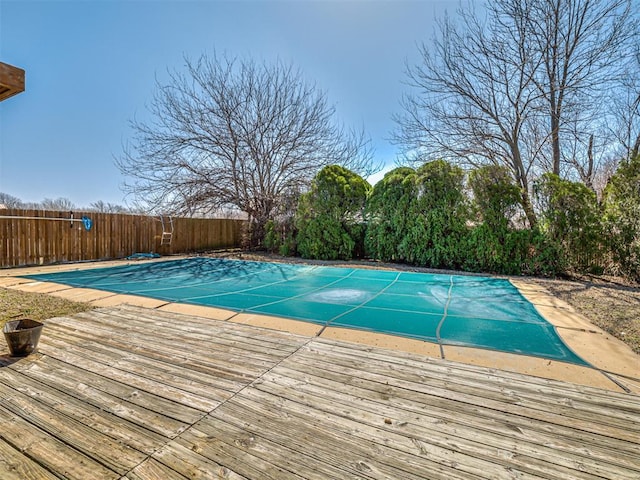 view of swimming pool with a fenced backyard, a fenced in pool, and a wooden deck