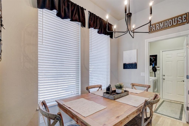 dining area with independent washer and dryer and wood finished floors