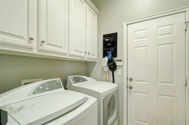 laundry room with washer and clothes dryer and cabinet space