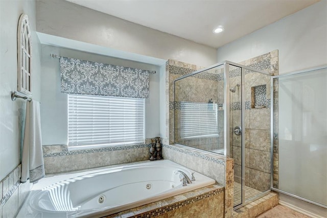 full bathroom with a shower stall and a whirlpool tub