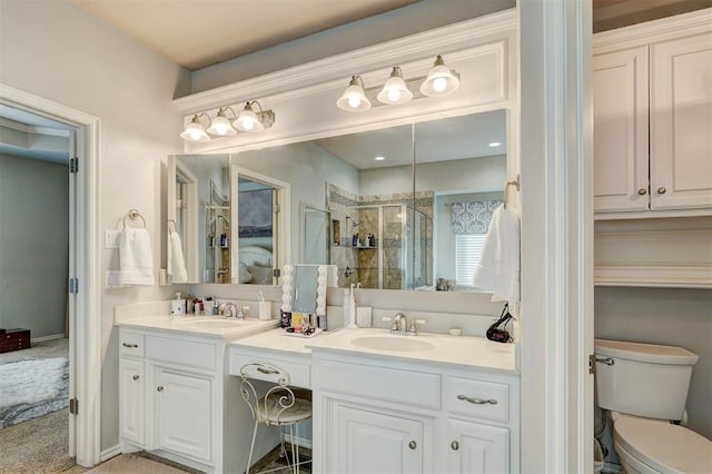 full bathroom featuring a sink, toilet, double vanity, and a shower stall