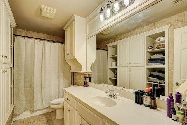 bathroom featuring visible vents, toilet, vanity, and tile patterned flooring