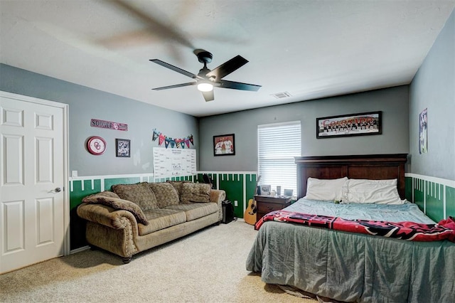 carpeted bedroom featuring visible vents and ceiling fan