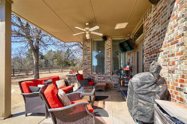 view of patio / terrace with an outdoor hangout area, ceiling fan, and fence