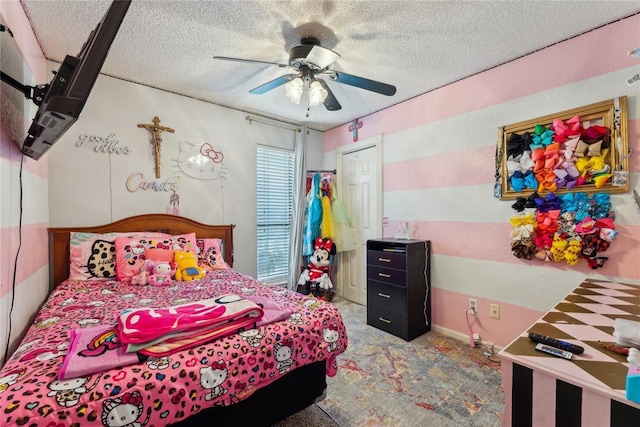 bedroom with a ceiling fan and a textured ceiling