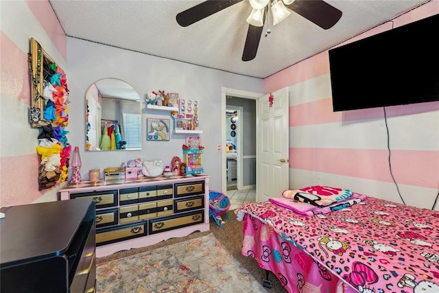 carpeted bedroom featuring a textured ceiling and ceiling fan