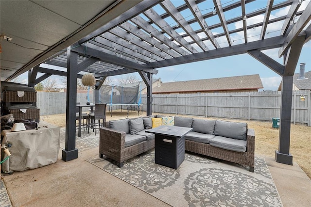 view of patio featuring an outdoor living space, a trampoline, a fenced backyard, and a pergola