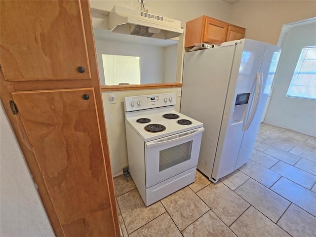 kitchen featuring white appliances, under cabinet range hood, and light tile patterned floors