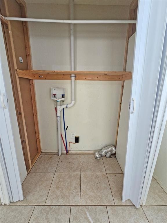 laundry area with washer hookup, laundry area, and light tile patterned flooring