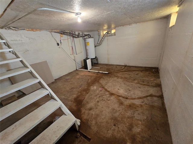 unfinished basement with gas water heater and concrete block wall
