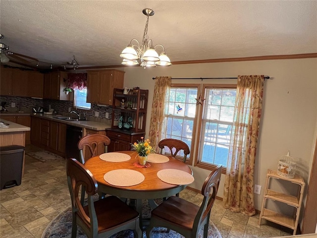 dining space featuring crown molding, stone finish flooring, a chandelier, and a textured ceiling