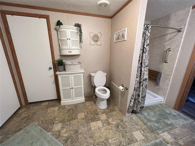 bathroom featuring a shower stall, a textured ceiling, toilet, and stone finish flooring