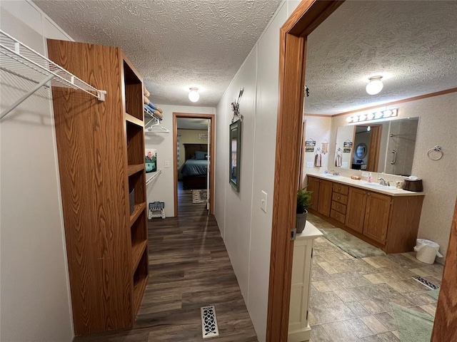 interior space with wood finished floors, visible vents, and a sink