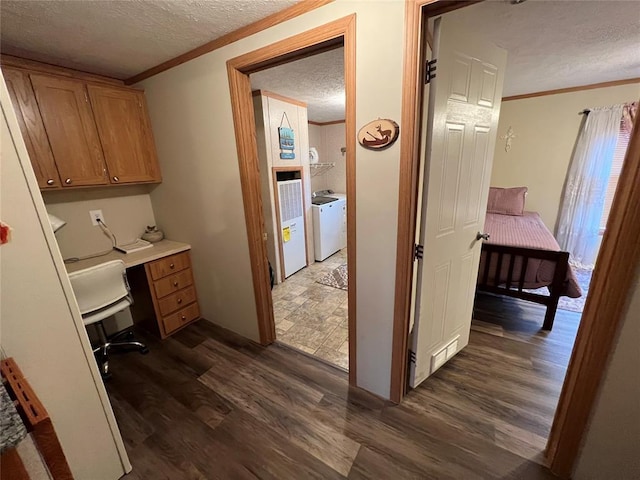 office area with crown molding, dark wood-style floors, washing machine and dryer, and a textured ceiling