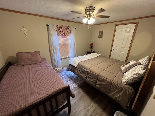 bedroom with a textured ceiling, a ceiling fan, wood finished floors, and ornamental molding