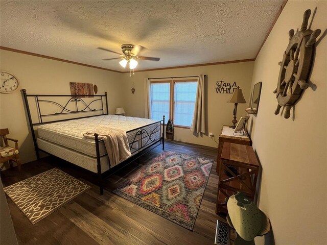 bedroom with ornamental molding, a textured ceiling, a ceiling fan, and dark wood-style flooring