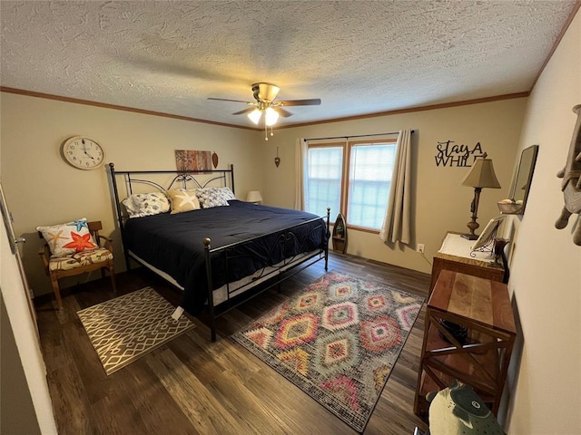 bedroom featuring ornamental molding, a textured ceiling, a ceiling fan, and wood finished floors