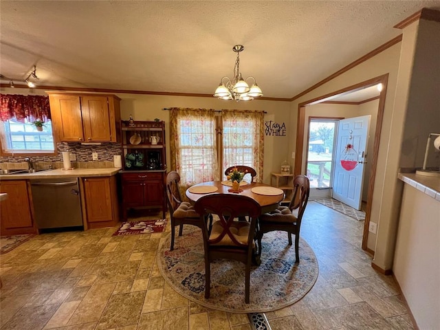 13132 Bluebird Ln, Kingston, OK 73439 - dining area featuring a chandelier, stone finish flooring, a textured ceiling, and crown molding