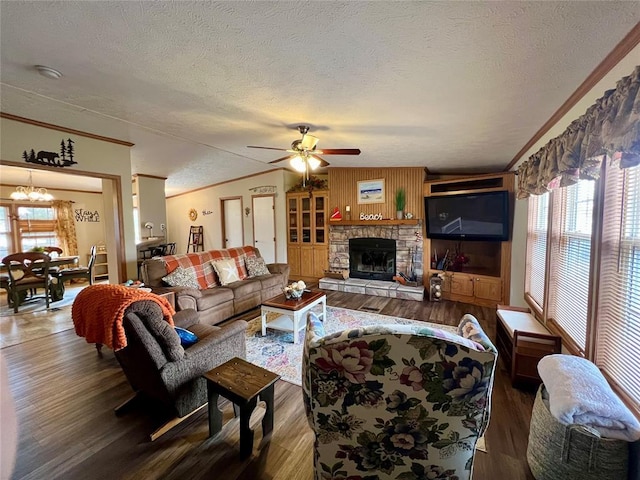 13132 Bluebird Ln, Kingston, OK 73439 - living area featuring dark wood-style floors, lofted ceiling, crown molding, and ceiling fan with notable chandelier