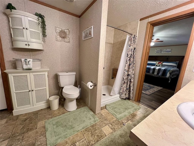 13132 Bluebird Ln, Kingston, OK 73439 - full bath with a ceiling fan, a stall shower, ornamental molding, a textured ceiling, and toilet
