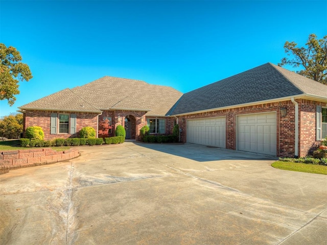 view of front of house with brick siding, roof with shingles, concrete driveway, and an attached garage